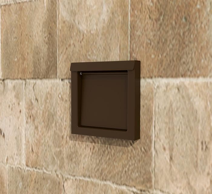 Photo of the brown DryerWallVent installed on a stone wall.